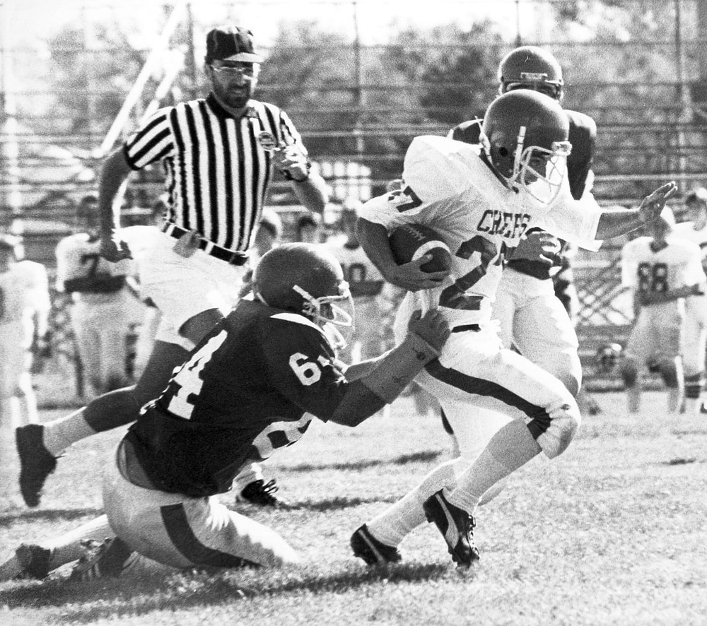 Football: Cutting Through the Defense — photojournalism by Jay Keenan